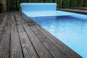 pool cover being rolled out over pool