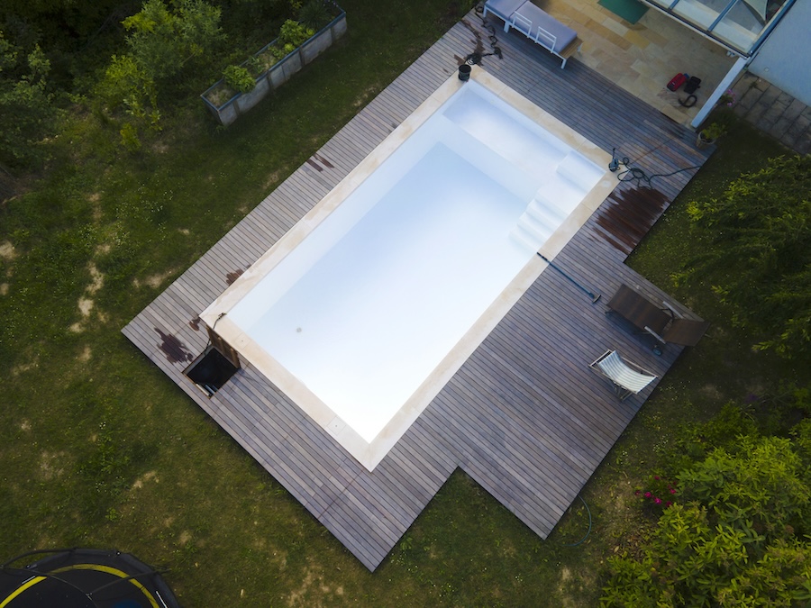 aerial drone shot of freshly cleaned pool filled with water