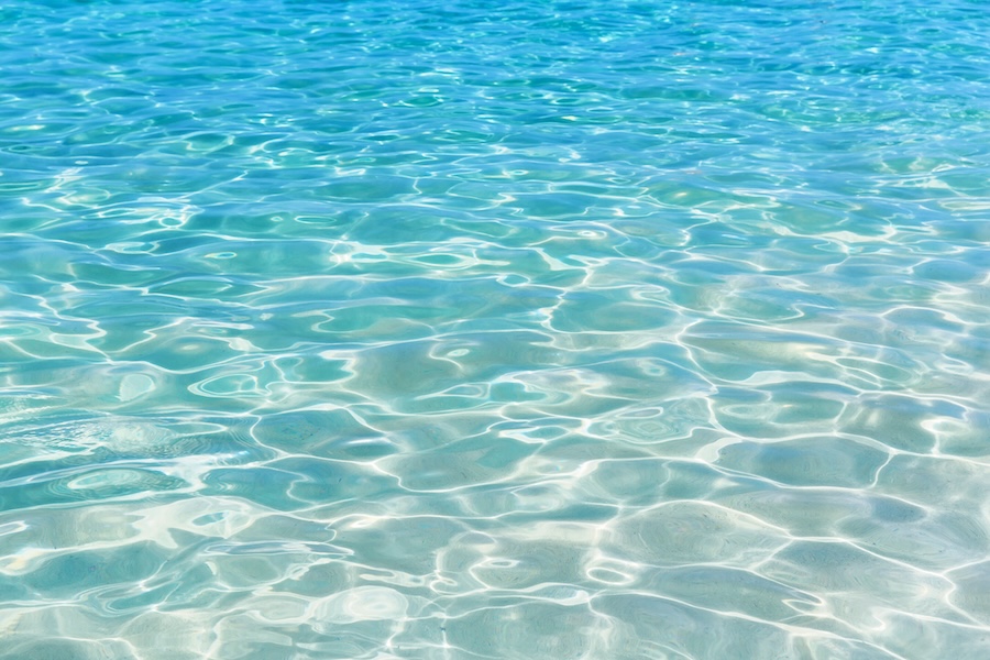Shining blue water ripple background.